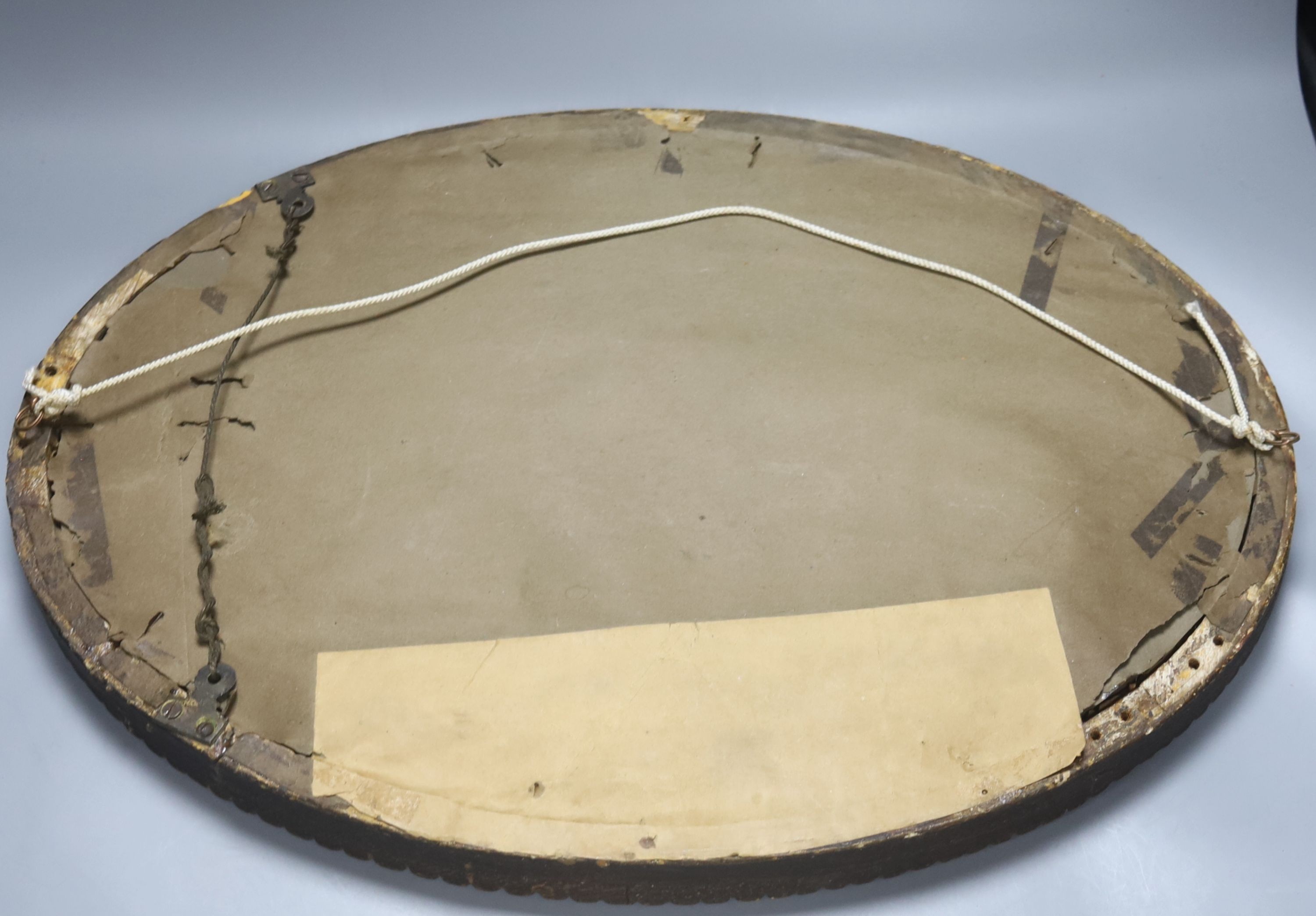 An oval gilt framed wall mirror, 55.5 cm high